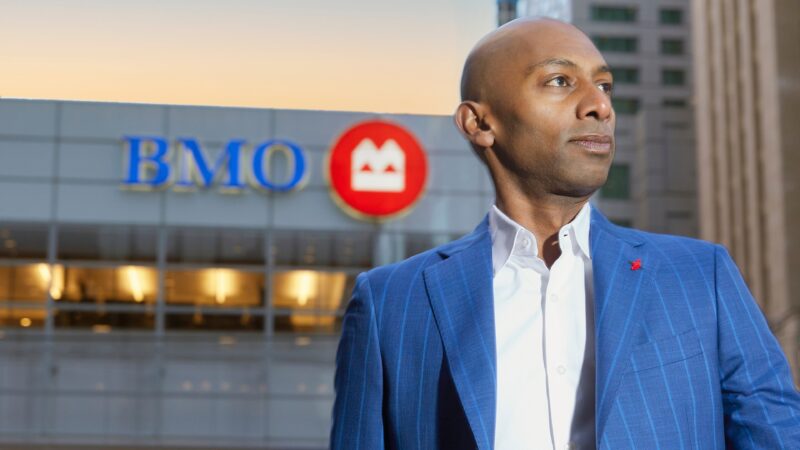 Rohit Thomas stands in front of a BMO sign