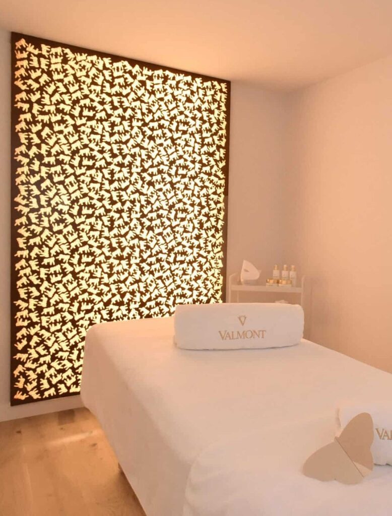 A luxurious room with a spa bed and towels. 