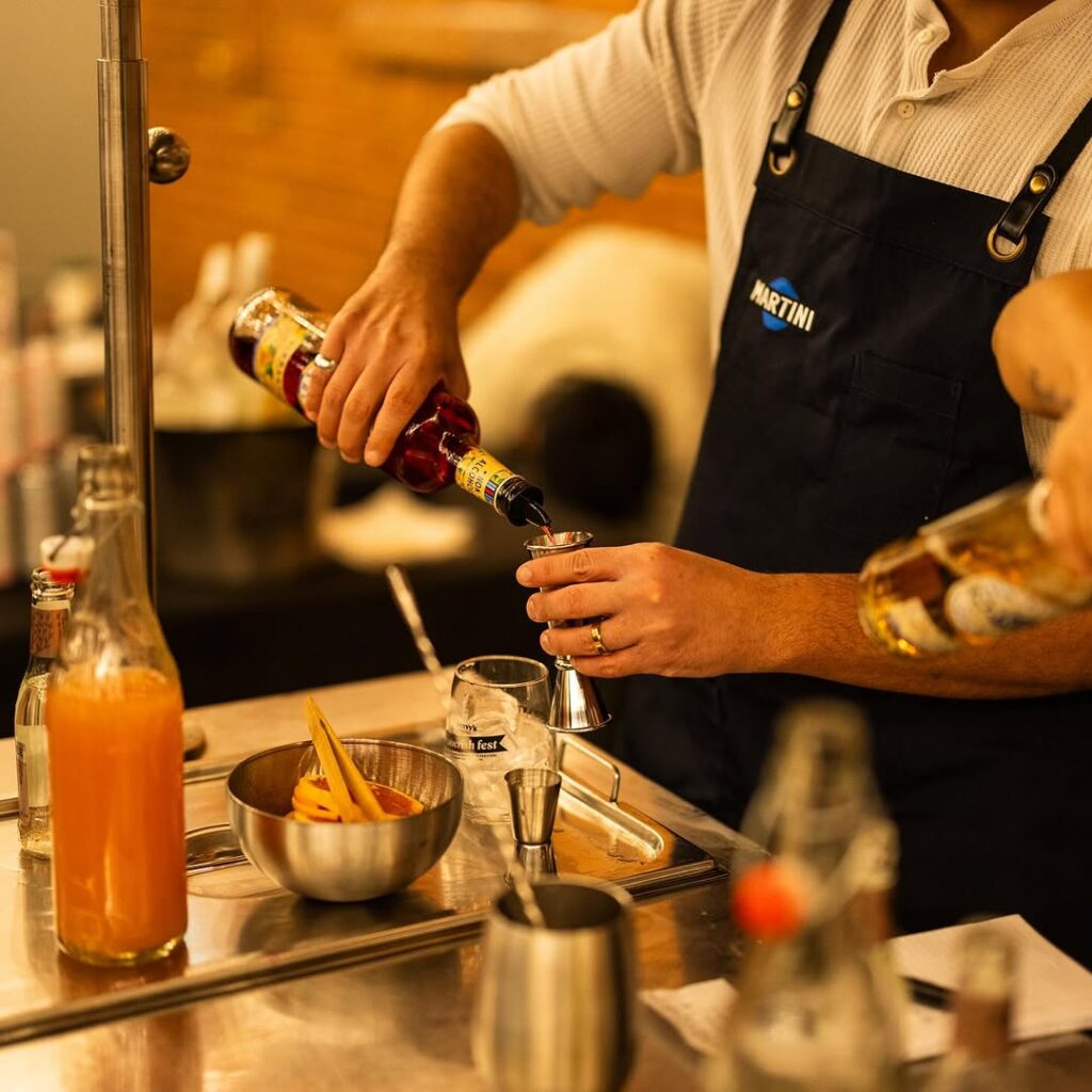 Bartender preparing a cocktail with non-alcoholic ingredients, showcasing the rise of mindful drinking and innovative beverage options in non-alcoholic bars.